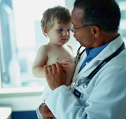 A doctor holding a baby