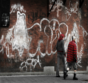 2 men with graffiti behind them